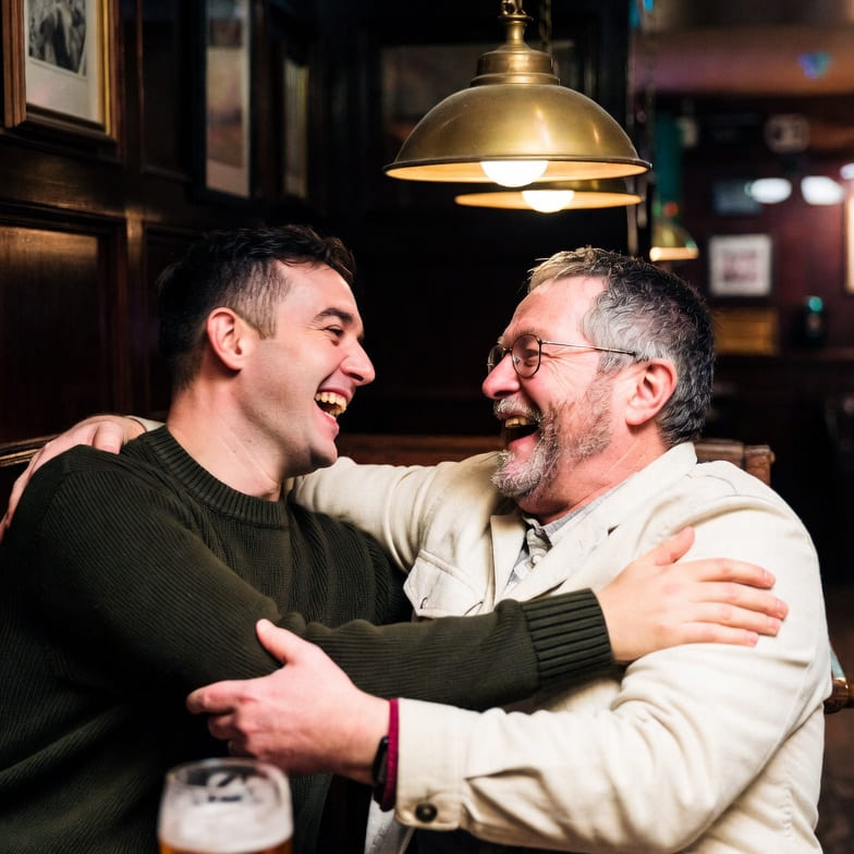 Two men sharing a laugh in a traditional pub in Dublin, Ireland