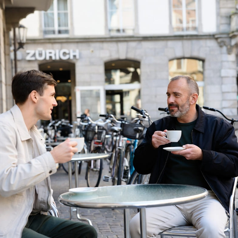 Two men enjoying a coffee in Zurich, representing gay dating in Switzerland